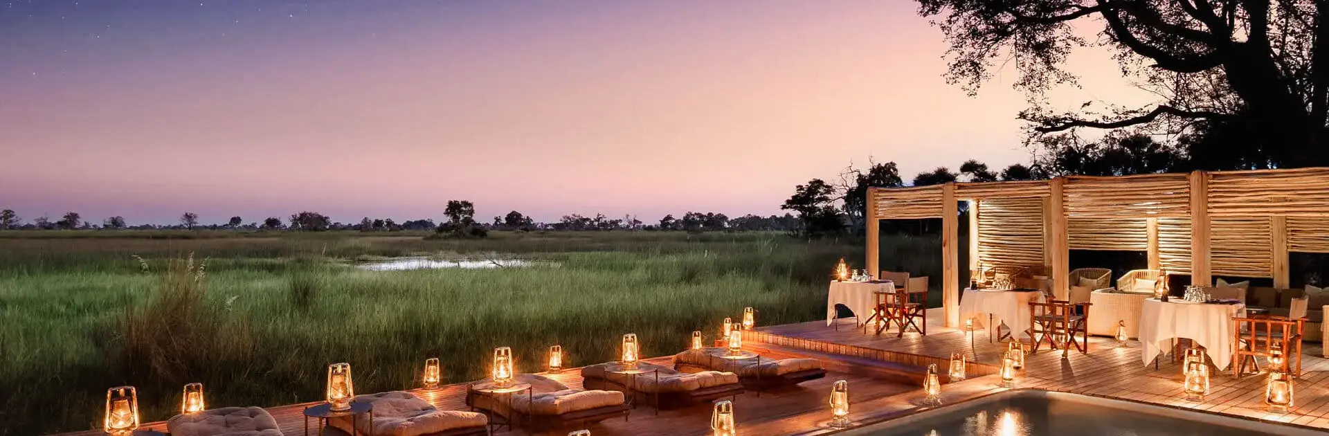 Sunset and candlelight around a lodge pool in the Okavango Delta in Botswana | Go2Africa